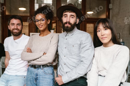 Preview: Image of multiethnic young business workers standing together at office