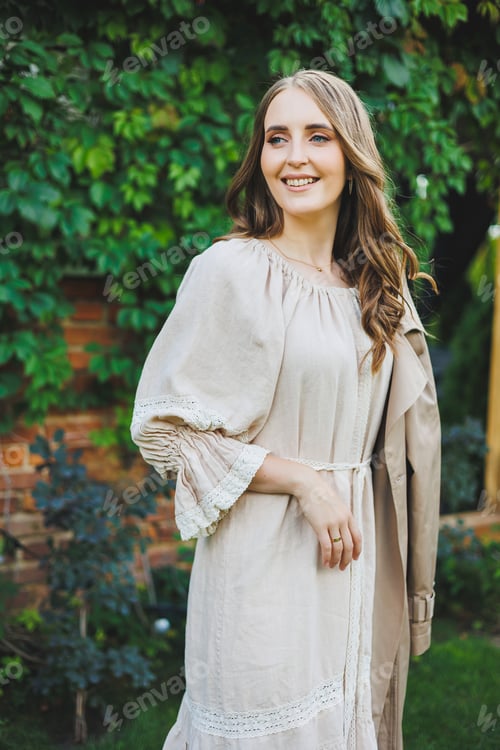 Preview: Portrait of a beautiful young woman in a light beige dress. Romantic woman in a dress with