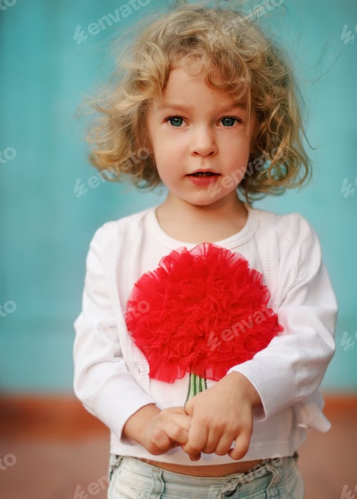 Preview: Portrait of a little cute curly girl outdoors