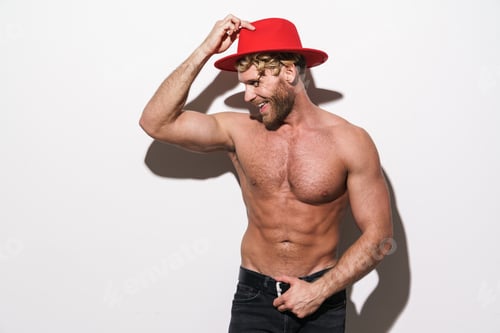 Preview: Shirtless blonde man wearing red hat smiling while posing on camera