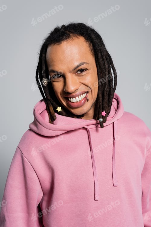 Preview: portrait of happy multiracial man with dreadlocks smiling isolated on grey
