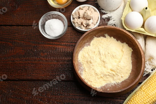 Preview: Cornbread preparation. Different ingredients on wooden table, flat lay. Space for text