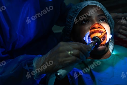 Preview: Dentist performing teeth whitening procedure on patient