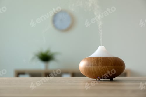 Preview: Modern aroma lamp on table against blurred background with space for text