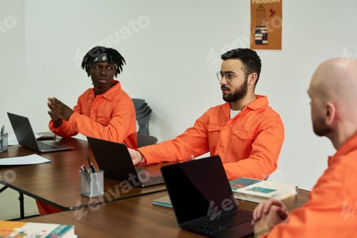 Preview: Multiethnic Young Adult Men Collaborating during Group Discussion in Classroom