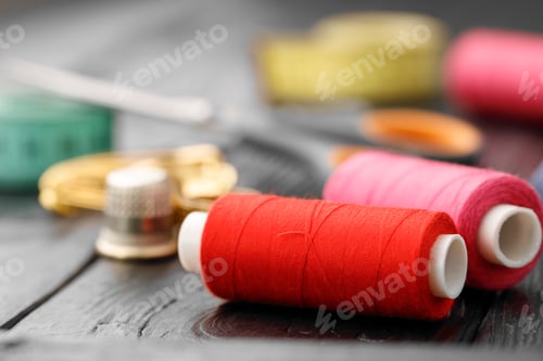 Preview: Colorful sewing utensils on black wooden surface