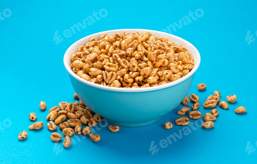 Preview: Puffed wheat cereal isolated on blue background