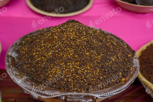 Preview: Container with mole powder. Typical Mexican food sold in a street market.
