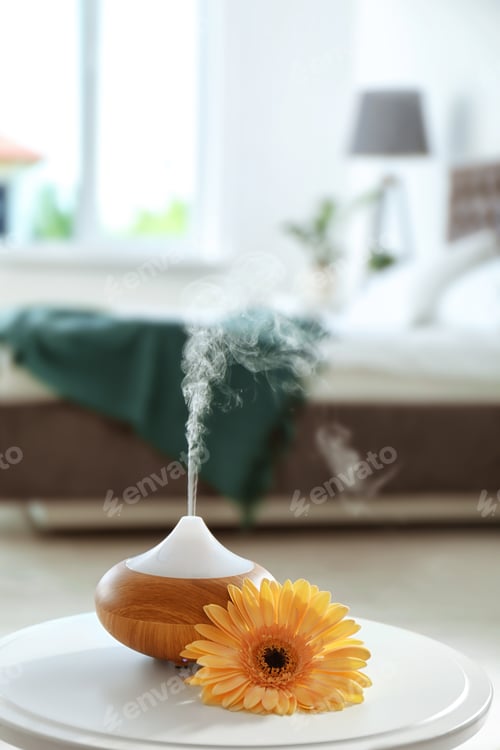 Preview: Aroma oil diffuser on table at home. Air freshener