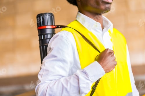 Preview: Close-up of an architect carrying a drawings tub