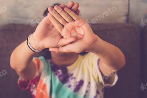 Preview: peace no war symbol painted on hand of young boy
