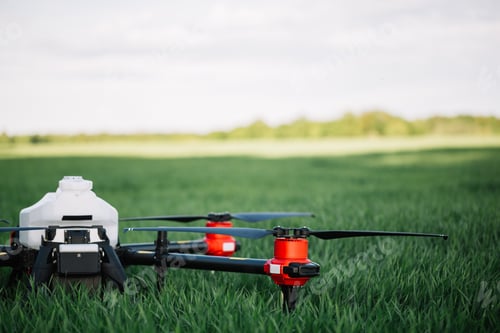 Preview: Agriculture drone flying on the green tea field at sunrise.