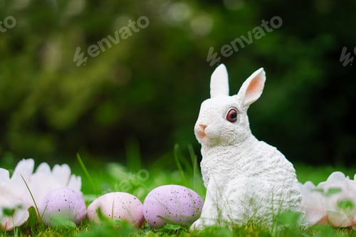 Preview: Easter background with bunny, eggs and flowers on green nature background with copy space