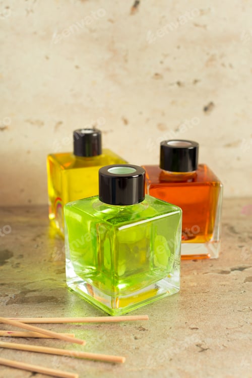 Preview: Three colorful glass bottles filled with vibrant liquid displayed on a textured surface