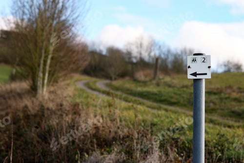 Preview: Selective focus shot of a road sign showing the way for hikers