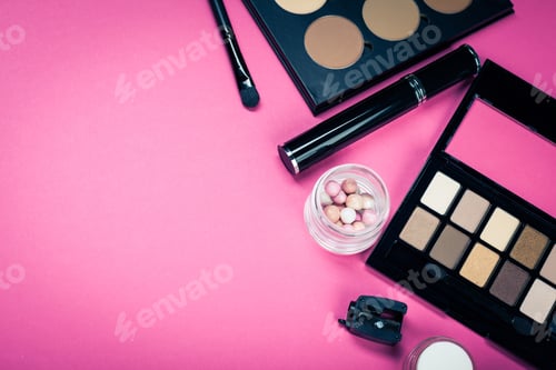 Preview: Set of colorful cosmetics on pink table