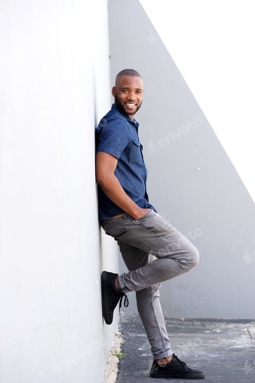 Preview: Full length stylish young black standing by wall
