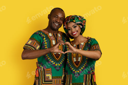 Preview: Beautiful black lovers showing heart-shaped symbol on yellow