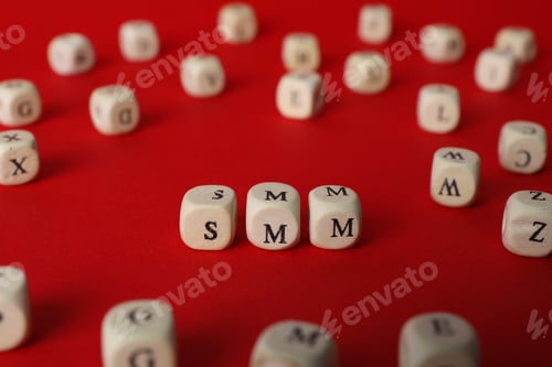 Preview: Wooden cubes with abbreviation SMM (Social media marketing) on red background