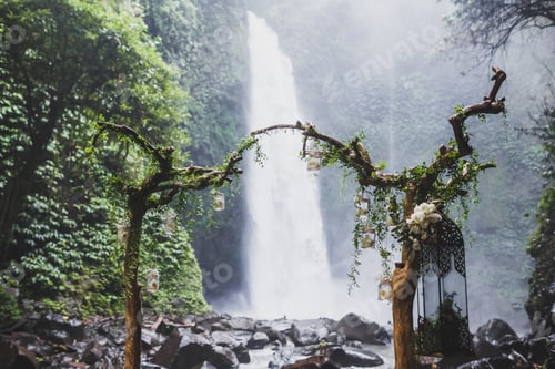 Preview: Tropical wedding ceremony with waterfall view in jungle canyon. Decorated with green ivy