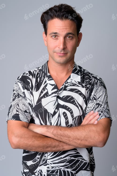 Preview: Portrait of handsome Hispanic tourist man with arms crossed