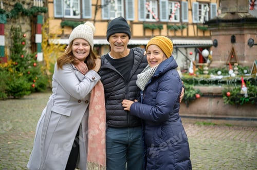 Preview: Happy family standing in downtown during Christmas holidays