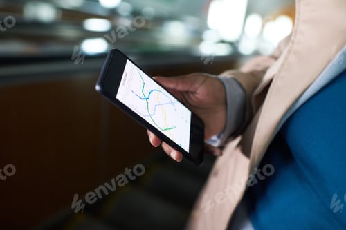 Preview: Close-up of smartphone with metro route map on screen in hand of young woman