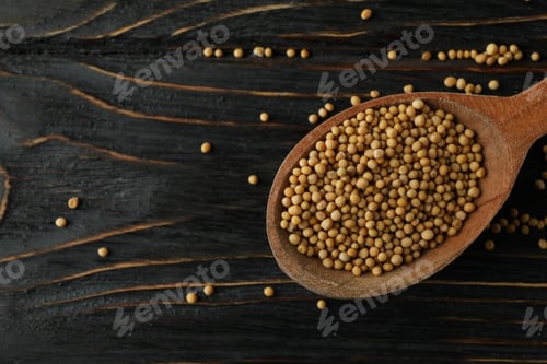 Preview: Wood spoon with mustard seeds on wooden background