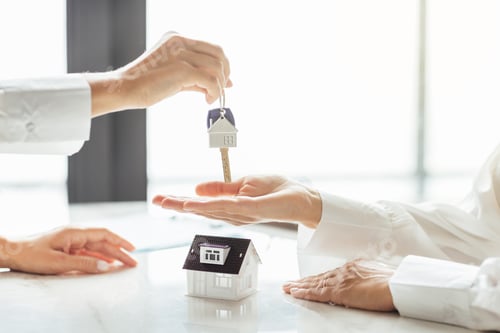 Preview: Homeowner getting key to new house apartment from realtor in modern office. Happy real estate owner
