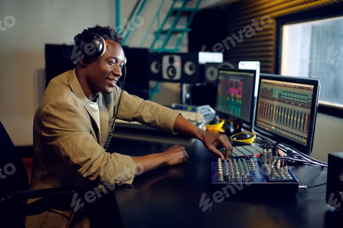 Preview: Male dj working on a new hit, recording studio