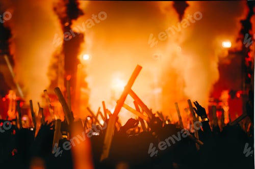 Preview: silhouettes of hand in concert.Light from the stage.