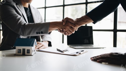 Preview: real estate broker manager hand shake to customer after signing contract for buying house.