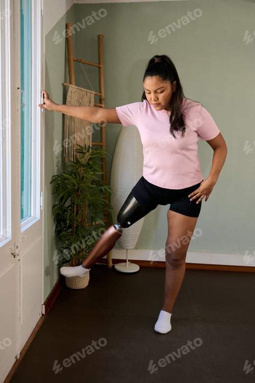 Preview: Woman with prosthetic leg exercising at home