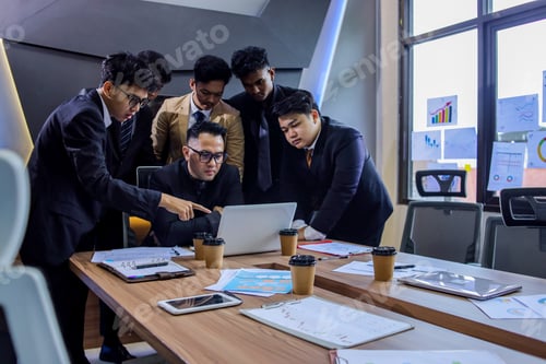 Preview: Businesspeople Looking at Laptop Together for Sharing Ideas in Office Meeting Room