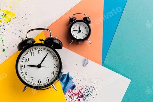 Preview: Vintage black alarm clock on a color block background