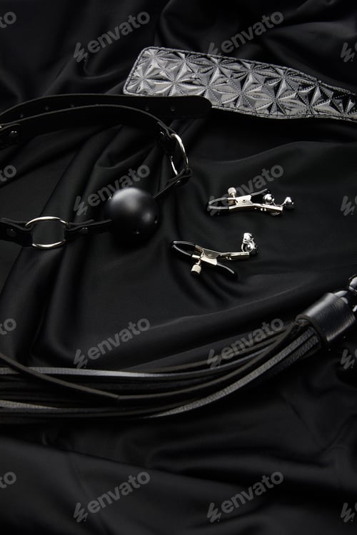 Preview: different sex toys on black textile background