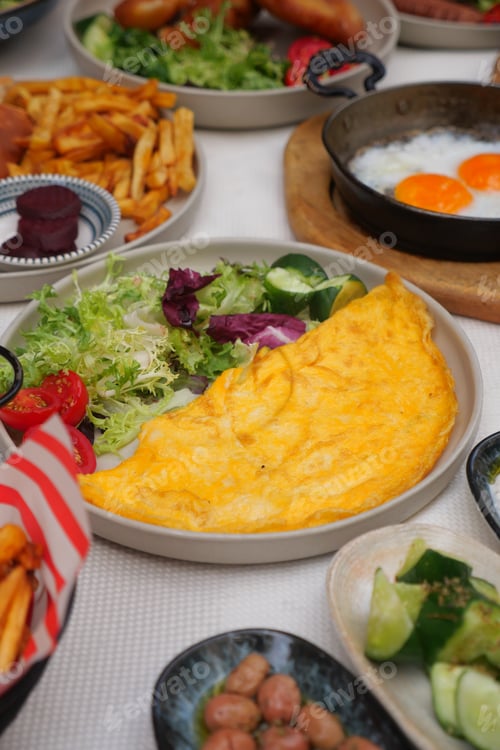 Preview: Delicious breakfast spread featuring omelette and sides