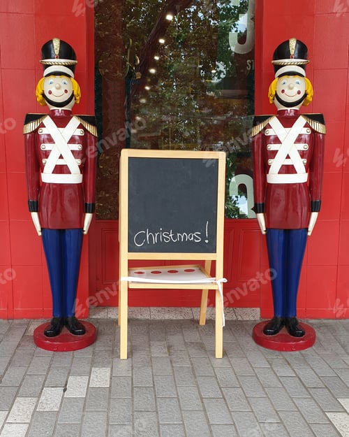 Preview: toy soldiers standing next to chalkboard with word Christmas