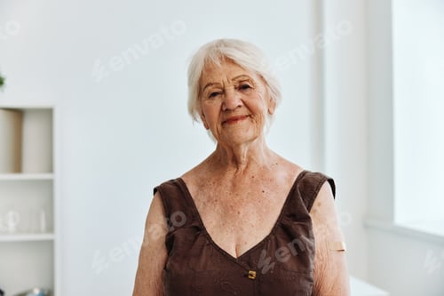 Vista previa: old woman with plaster on her arm covid passport immunization safety