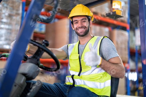 Preview: Forklift Truck Operator Lifts Pallet Cardboard Boxes On a Shelf by Trucks smiling portrait