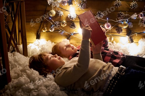 Preview: Children Reading a Book with Christmas Decorations