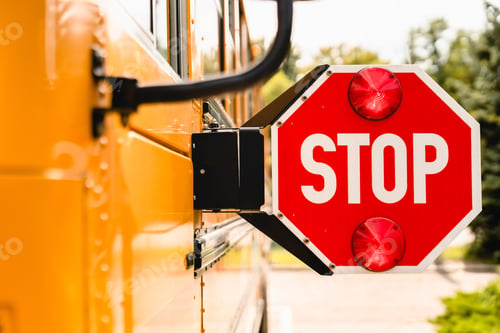 Preview: Close up yellow school bus. Stop sign. Be careful, schoolchildren crossing the road.
