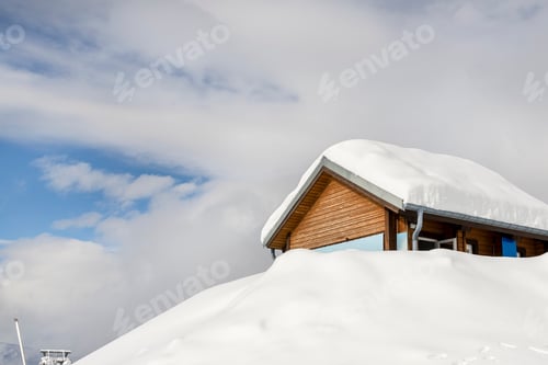 Preview: Scenic view highland alpine modern wooden rescue hut bar house snowbound covered snow layer after