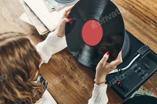 Preview: Woman playing music from vinyl record. Analog record. Retro and vintage style. Analog sound. Music
