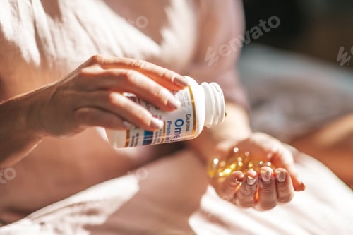 Preview: female hands hold vitamin jelly capsules pills