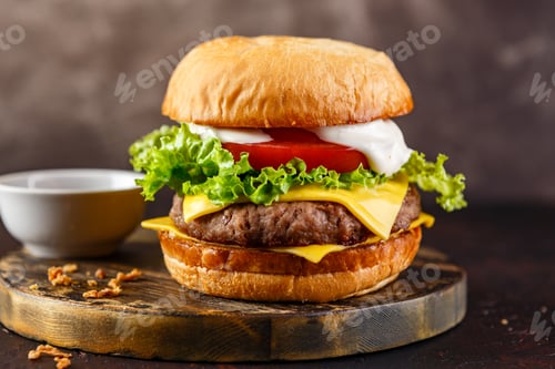 Preview: Close-up of home made tasty burger on wooden table.