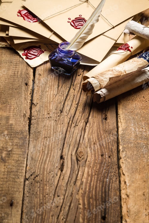 Preview: Old rolls of paper and blue ink in the inkwell as vintage background