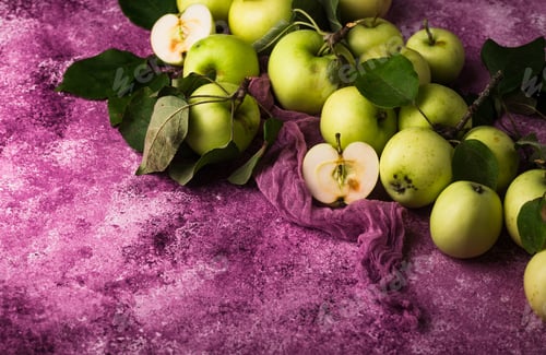 Preview: Fresh ripe green apple in purple background.