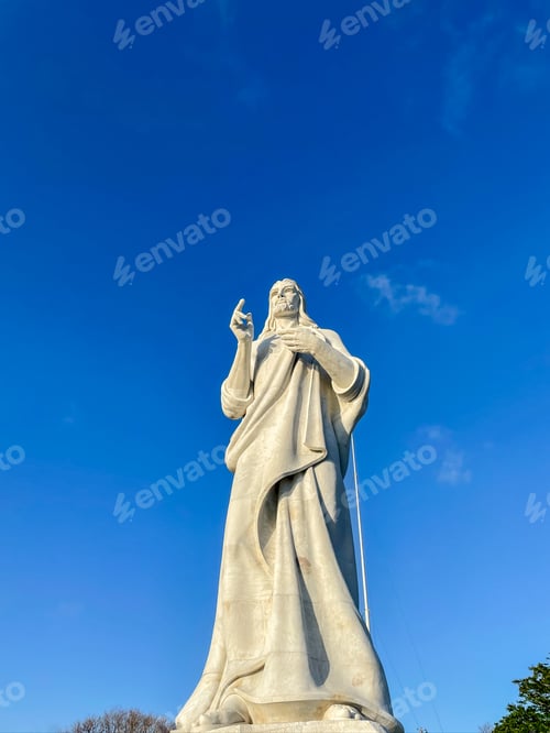Preview: Marble statue of Christ in Havana, Cuba. Low angle view against a clear blue sky