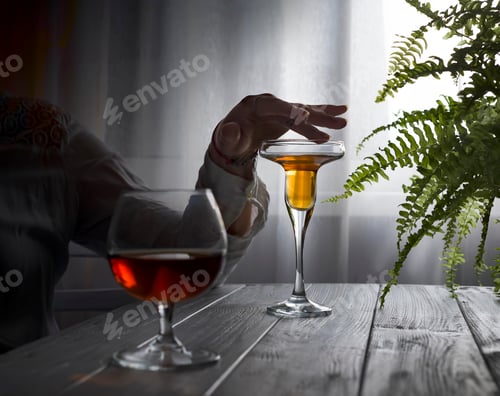 Preview: Young beautiful woman in depression, drinking alcohol on dark background